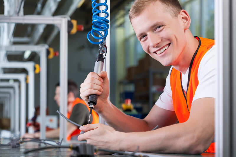 first-aid-course-young-smiling-man-working-on-the-production-line